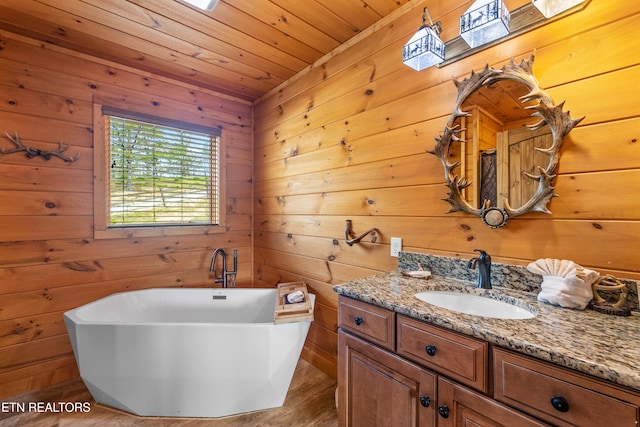 bathroom featuring vanity, wood walls, a bathing tub, wood-type flooring, and wood ceiling