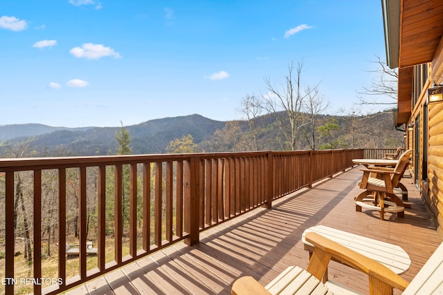 wooden deck with a mountain view