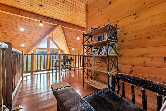 sitting room with wooden walls, lofted ceiling with beams, wood-type flooring, and wood ceiling