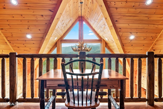 interior space with lofted ceiling with beams, hardwood / wood-style flooring, an inviting chandelier, and wood ceiling