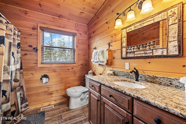 bathroom featuring vanity, wood walls, lofted ceiling, wood-type flooring, and wood ceiling