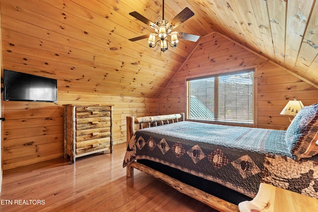 bedroom with hardwood / wood-style floors, wood walls, and wood ceiling