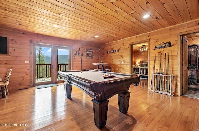 playroom featuring french doors, light wood-type flooring, wood ceiling, wood walls, and pool table