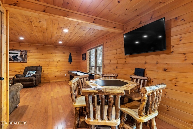 dining room with pool table, light wood-type flooring, wooden walls, and wooden ceiling