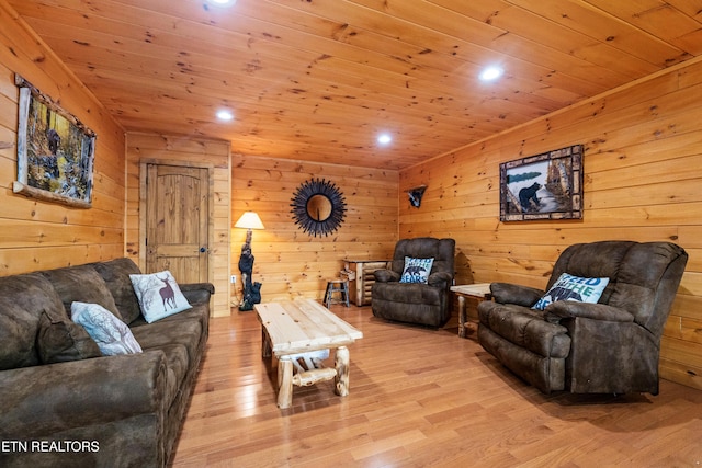 living room with wood walls, light hardwood / wood-style floors, and wooden ceiling