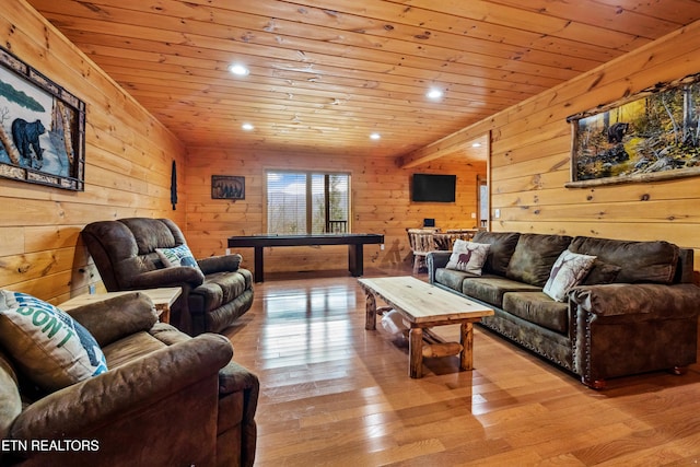 living room with wood walls, light hardwood / wood-style floors, and wooden ceiling