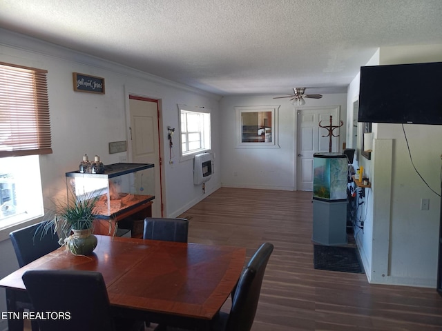 dining room featuring dark hardwood / wood-style floors, ceiling fan, a textured ceiling, and heating unit