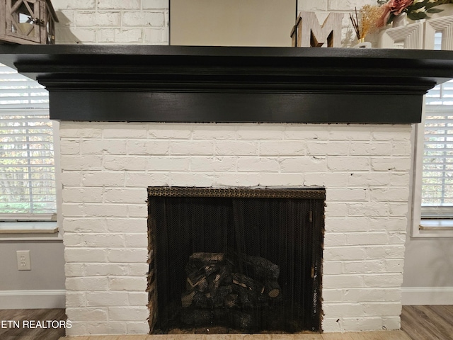 interior details with a fireplace and wood-type flooring