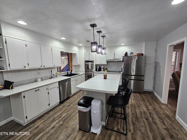 kitchen featuring white cabinets, stainless steel appliances, and dark wood-type flooring