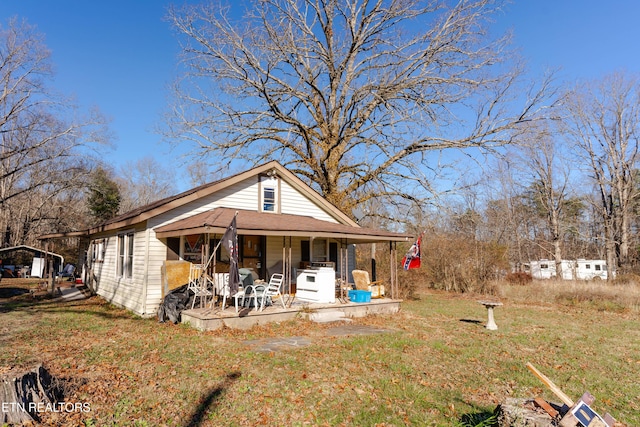 view of front of property with covered porch and a front lawn