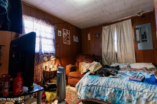 bedroom with electric panel and wooden walls