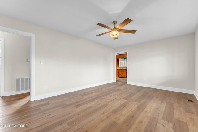 unfurnished room featuring ceiling fan and light hardwood / wood-style floors