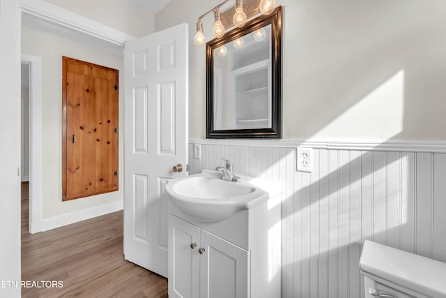 bathroom featuring vanity, toilet, and wood-type flooring