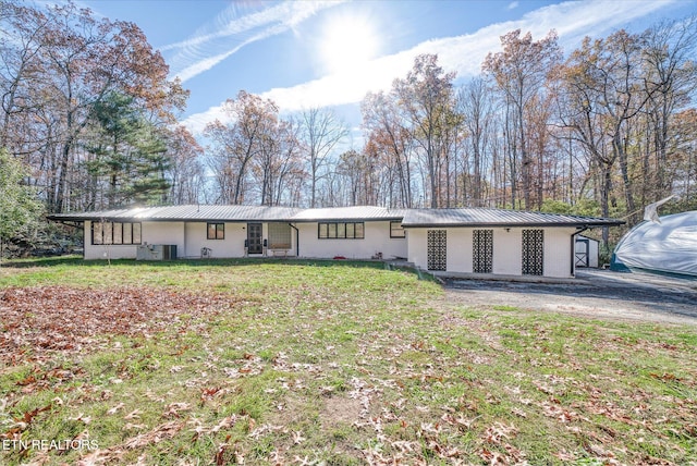 ranch-style house with a front lawn and central AC