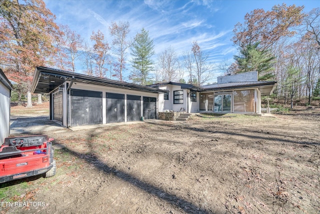 rear view of property featuring a sunroom