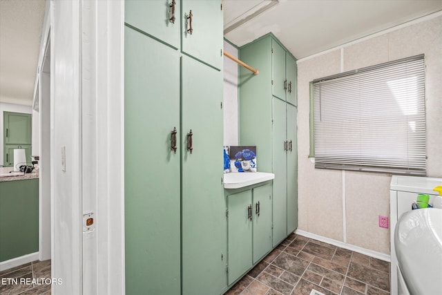 bathroom with vanity and washer / dryer