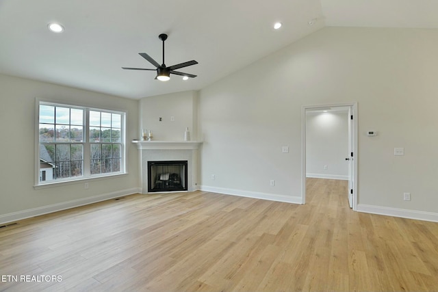 unfurnished living room with vaulted ceiling, light hardwood / wood-style floors, and ceiling fan