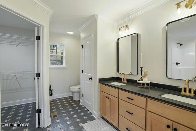 bathroom featuring ornamental molding, toilet, and vanity