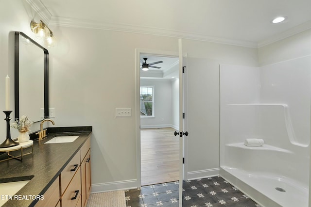 bathroom with ornamental molding, vanity, and walk in shower