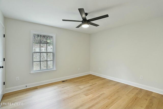 empty room featuring ceiling fan and light hardwood / wood-style floors