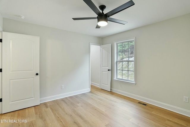 unfurnished bedroom with ceiling fan and light wood-type flooring