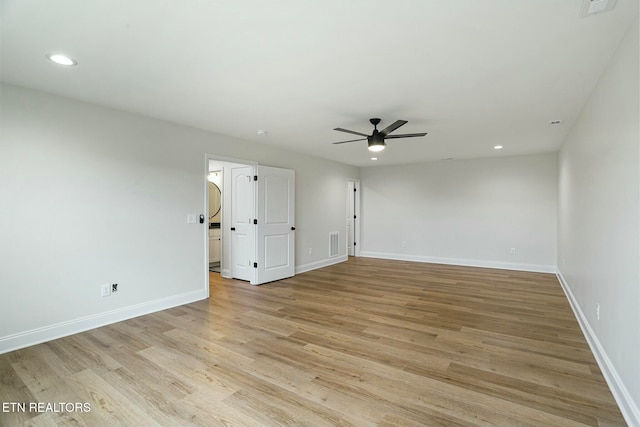 spare room featuring ceiling fan and light hardwood / wood-style flooring