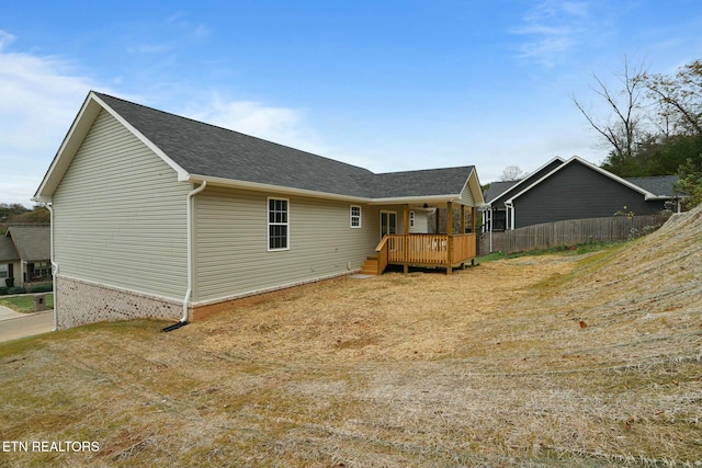 rear view of house featuring a wooden deck