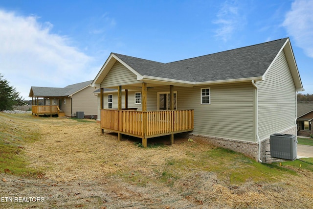 back of house featuring cooling unit, a yard, and a deck