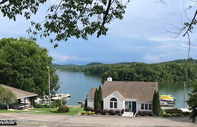 property view of water featuring a forest view