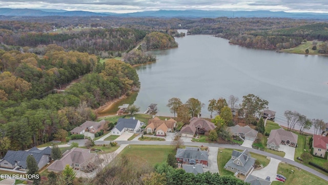 bird's eye view with a residential view, a water and mountain view, and a view of trees