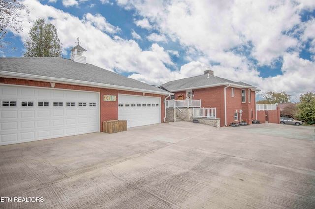 view of side of home featuring a garage