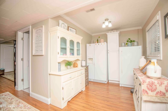 kitchen with white cabinets, light hardwood / wood-style floors, white refrigerator with ice dispenser, and crown molding