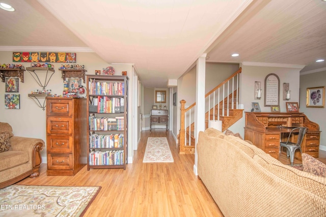 living room featuring light hardwood / wood-style flooring and ornamental molding