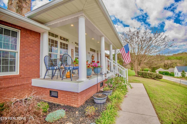 view of home's exterior featuring crawl space, a porch, and a lawn