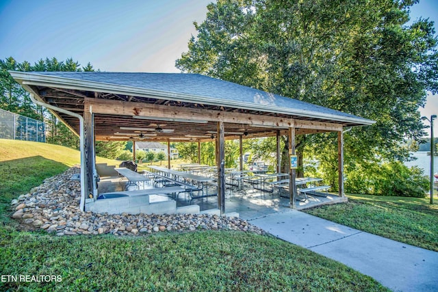 surrounding community with a patio and a yard