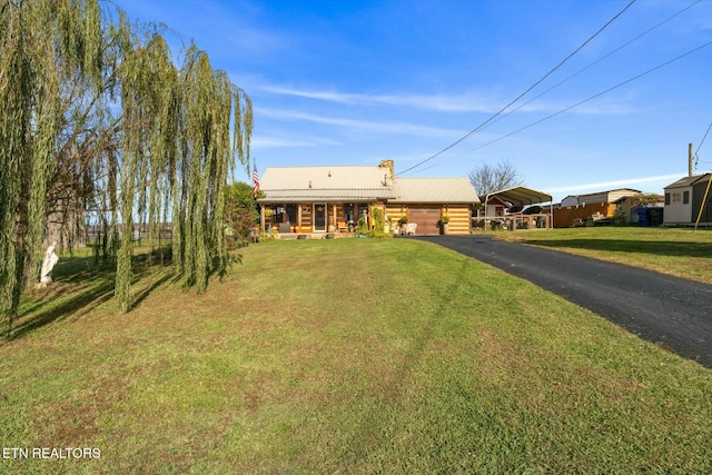 single story home with a front yard and a carport