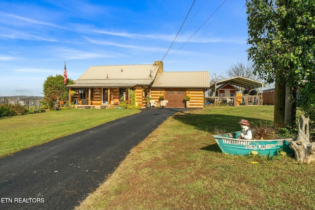 log cabin featuring a front lawn, covered porch, and a carport