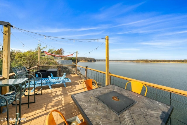 dock area featuring a deck with water view