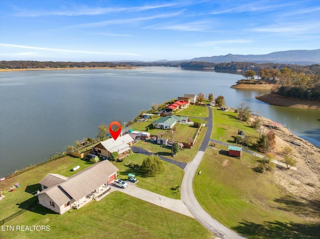 drone / aerial view featuring a water and mountain view