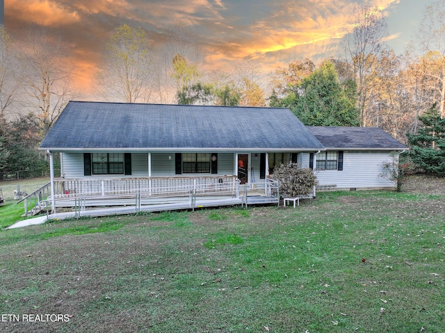 ranch-style home featuring a yard