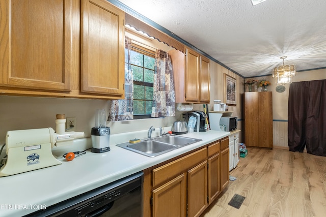 kitchen featuring light wood-type flooring, a textured ceiling, black appliances, sink, and a chandelier