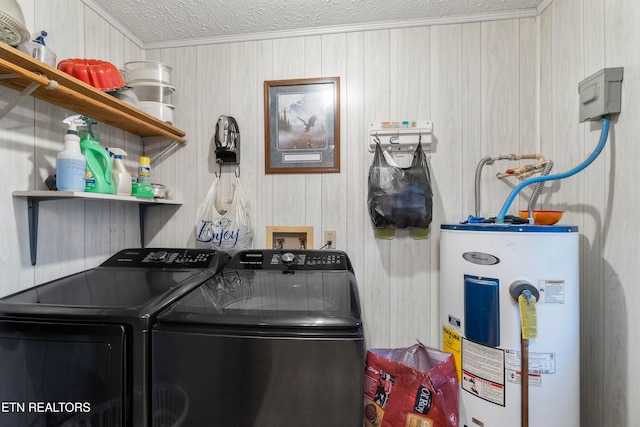 clothes washing area featuring washer and dryer, a textured ceiling, crown molding, and water heater