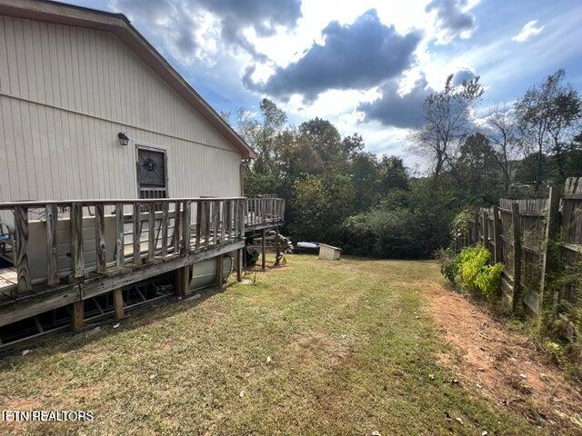 view of yard with a wooden deck