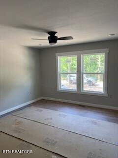 unfurnished room with ceiling fan and a healthy amount of sunlight