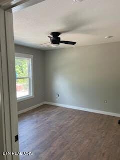 empty room with ceiling fan, baseboards, and wood finished floors