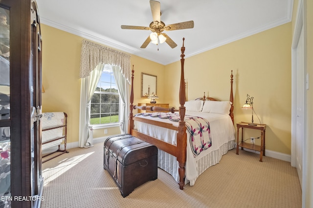 bedroom featuring ceiling fan, crown molding, and light colored carpet