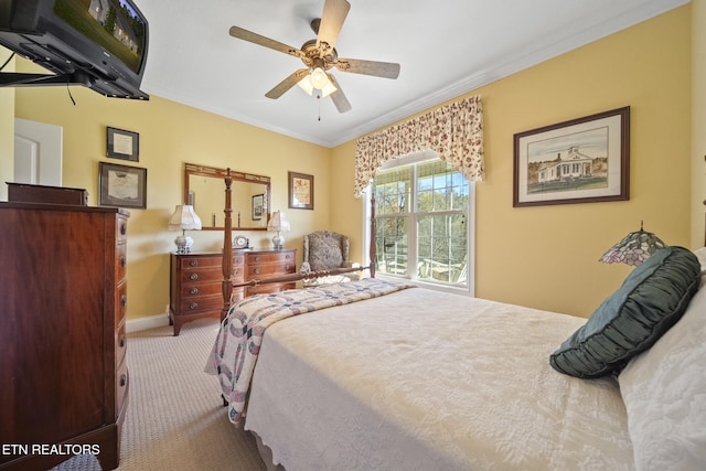 carpeted bedroom with ceiling fan and ornamental molding