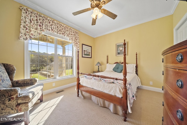 bedroom with ceiling fan, crown molding, and light colored carpet