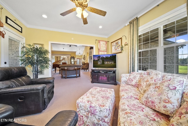 living room with ceiling fan, carpet floors, and crown molding