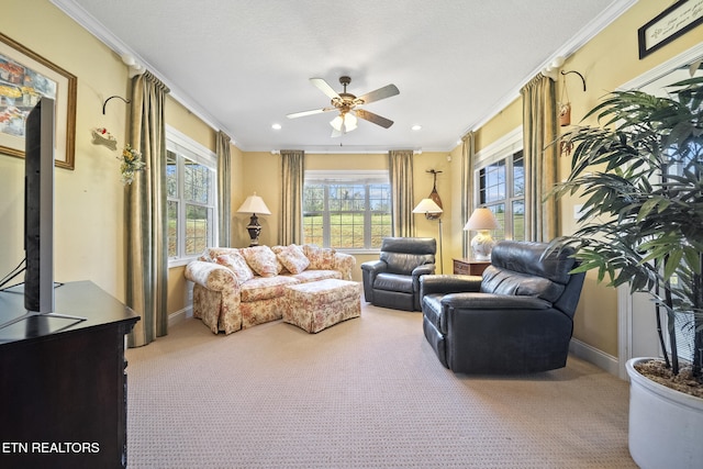 sitting room featuring carpet flooring, crown molding, and ceiling fan